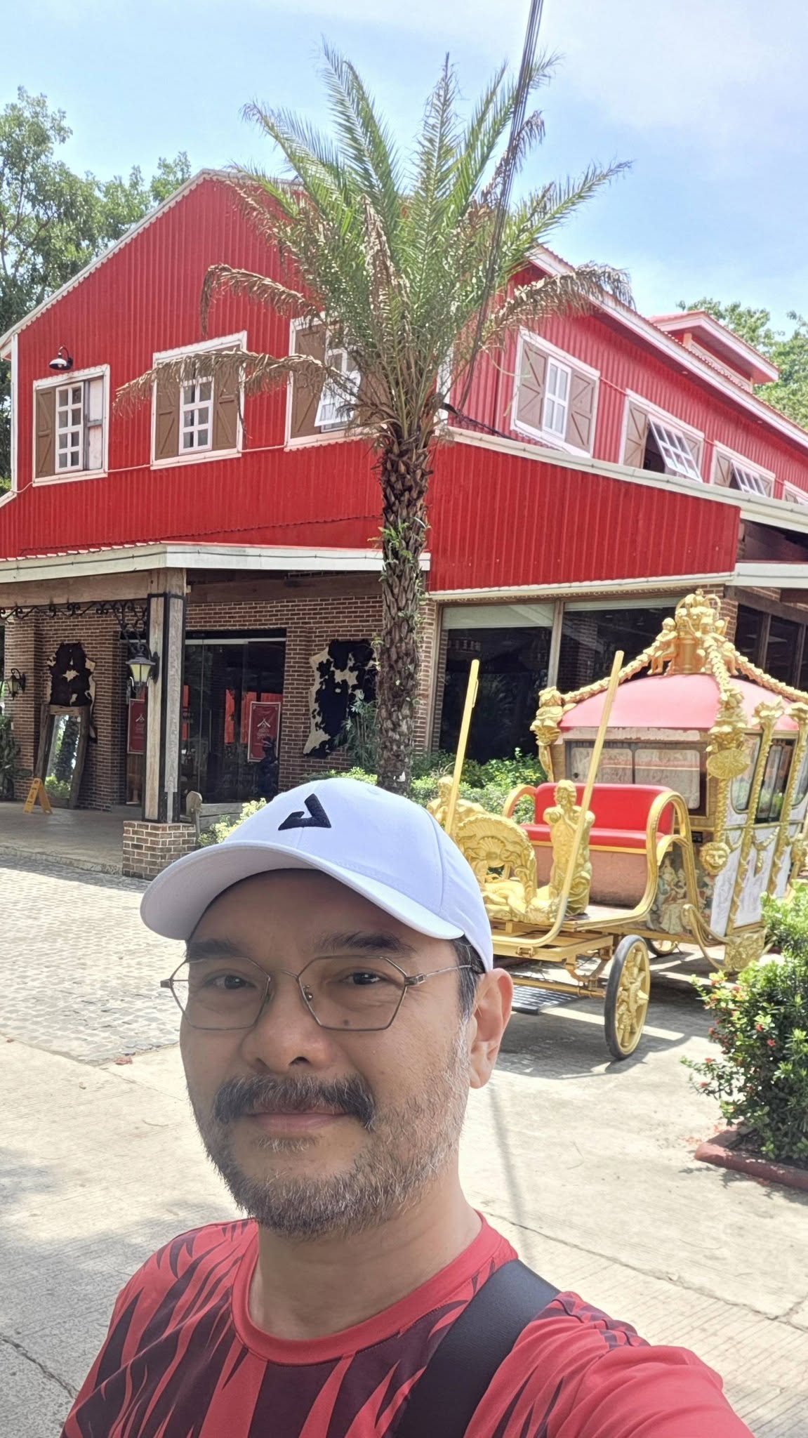Wency Cornejo in front of The Stable and its golden carriage at Rancho Blanco
