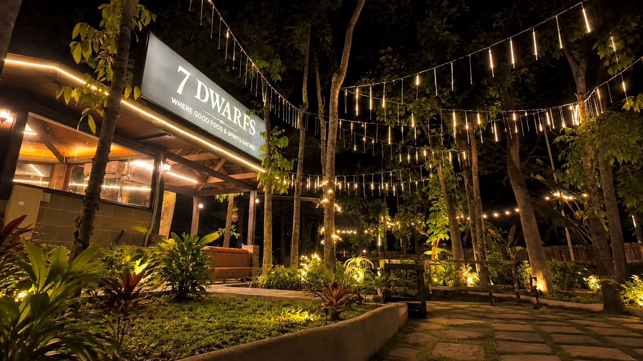 7 Dwarfs Bar at night under string lights